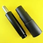 Dwa czarne siłowniki gazowe na żółtym tle